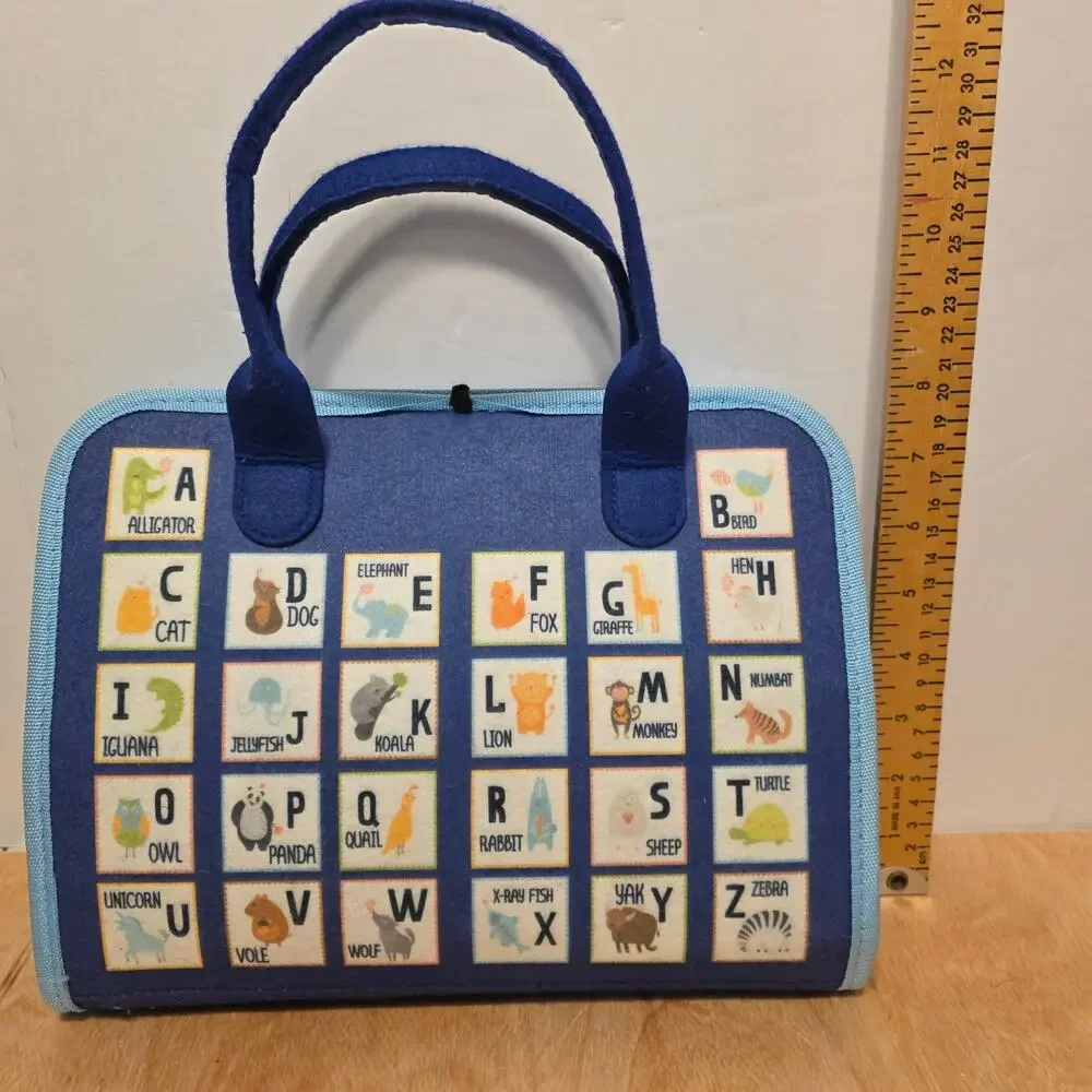 Esjay Toddler Busy Board in a portable dinosaur-themed felt carry case
